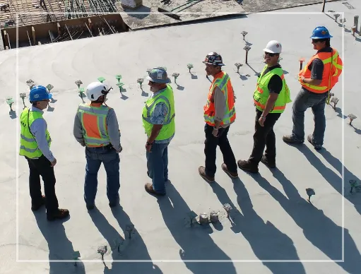 Men in construction vests standing and talking